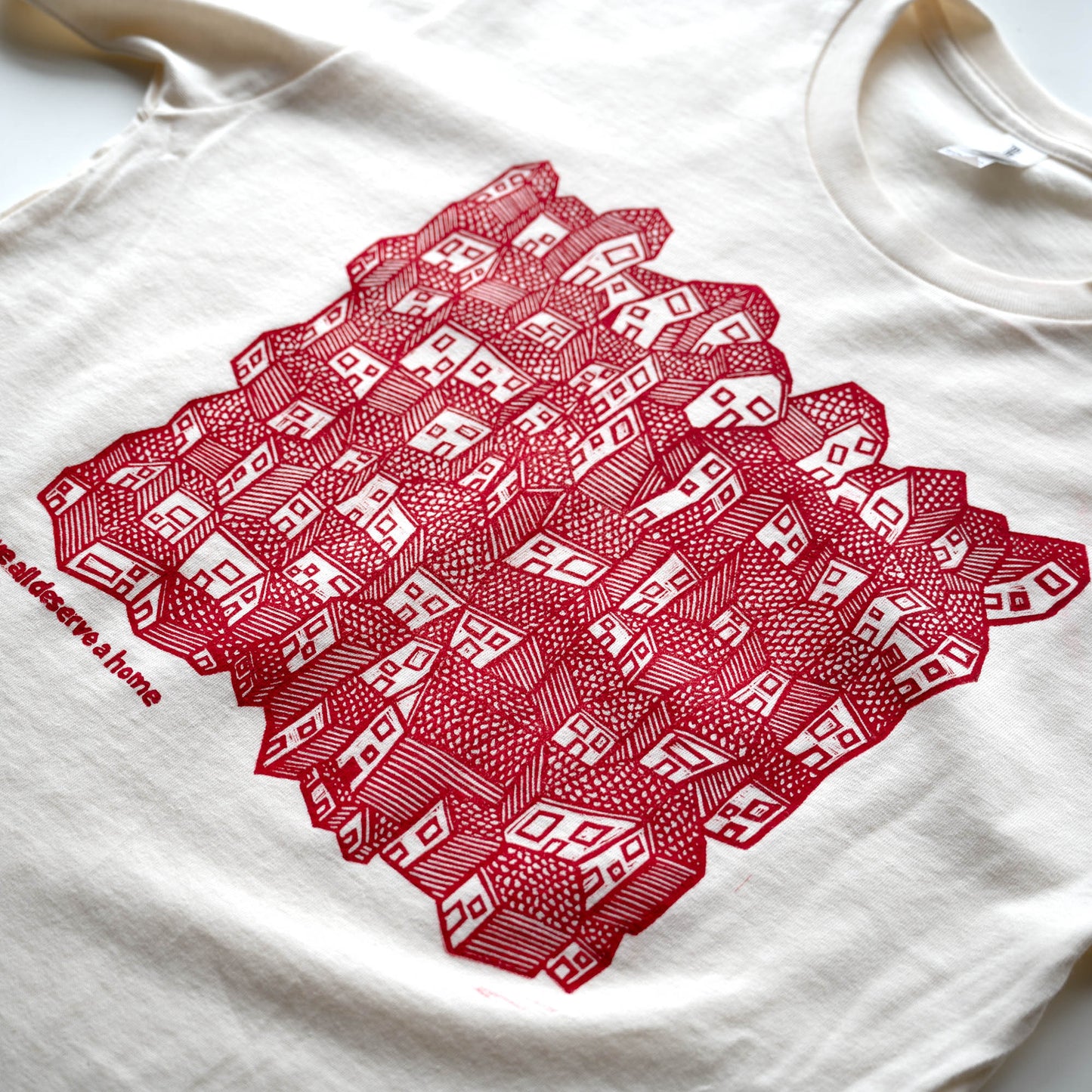 White t-shirt with red geometric pattern on a white background