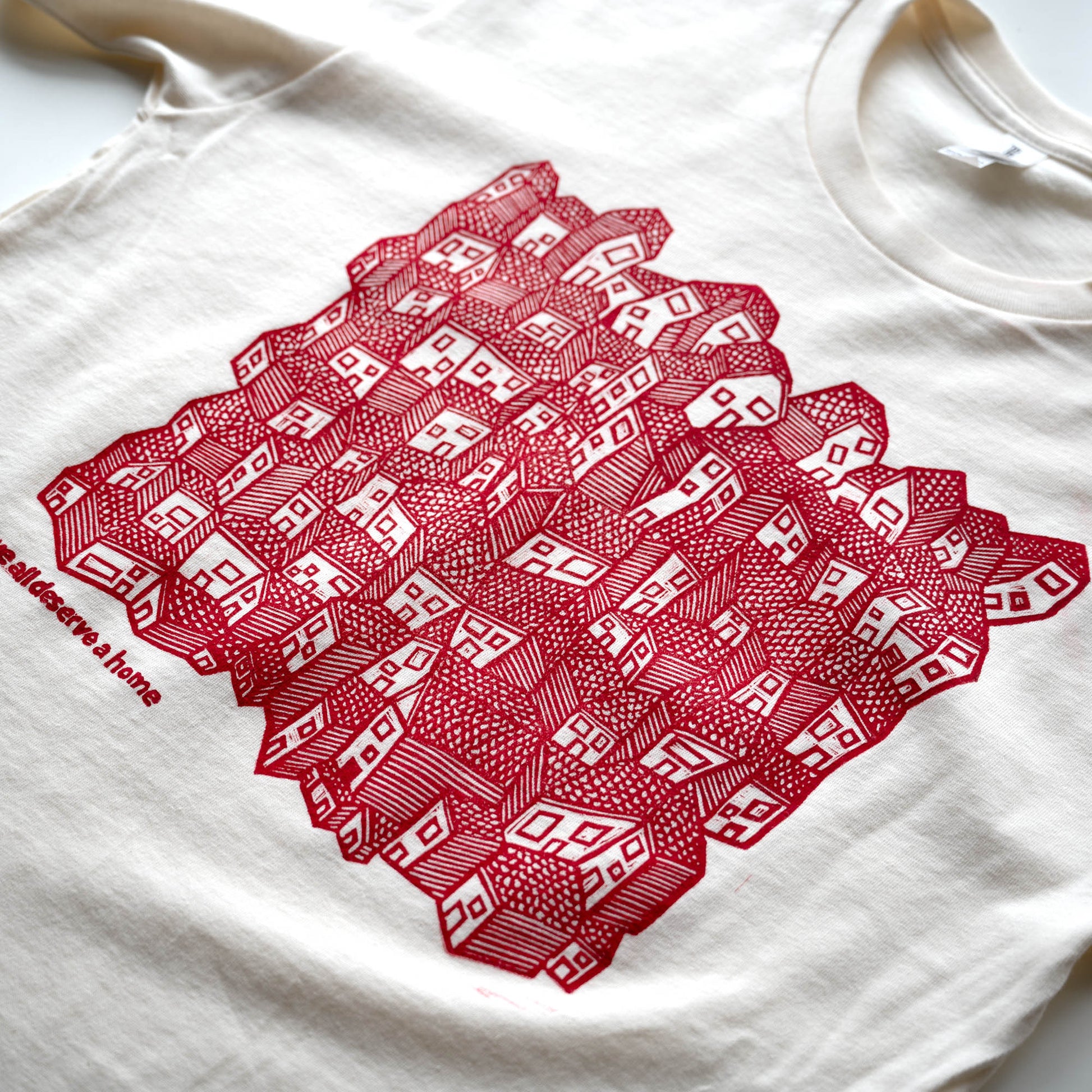 White t-shirt with red geometric pattern on a white background